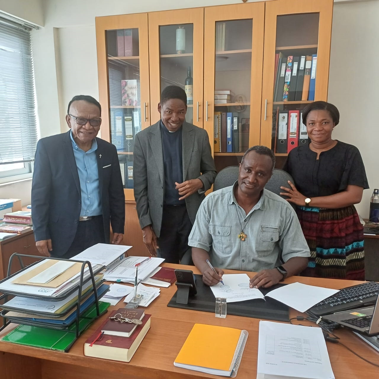 The Major Superior of the Consolata Fathers signing the Memorandum of Understanding with SECAM in the presence of SECAM Management. This M.U. assigned Fr. Stephen Okello, a consolate Priest, as a Liaison Officer for SECAM-AU office in Addis Ababa.